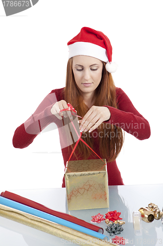 Image of young woman is packing  present for christmas isolated