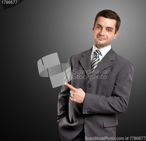 Image of Business Man Shows Something With Finger