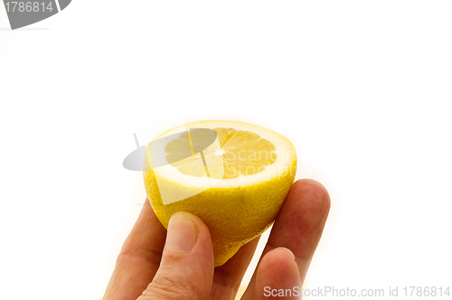 Image of fresh half lemon on hand