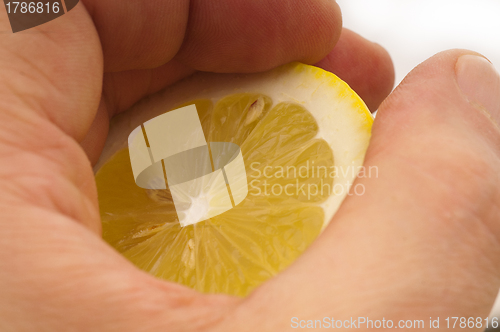 Image of fresh half lemon on hand