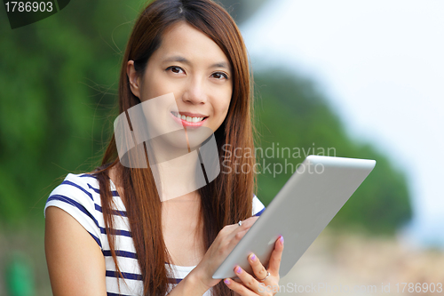 Image of asian woman using tablet computer