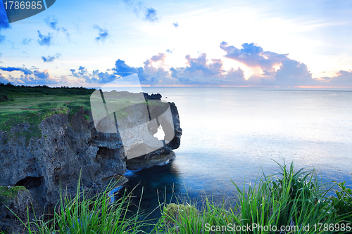 Image of sunset on the rocks , in Okinawa , Manzamo