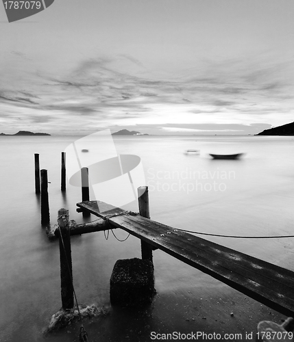 Image of pier at sunset in black and white