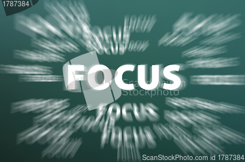 Image of Focus word with motion rays on green chalkboard background 