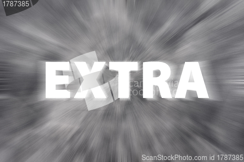 Image of Chalk drawing of "Extra" word written on blurred chalkboard 