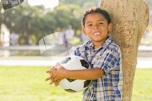 Image of Mixed Race Boy Holding Soccer Ball in the Park