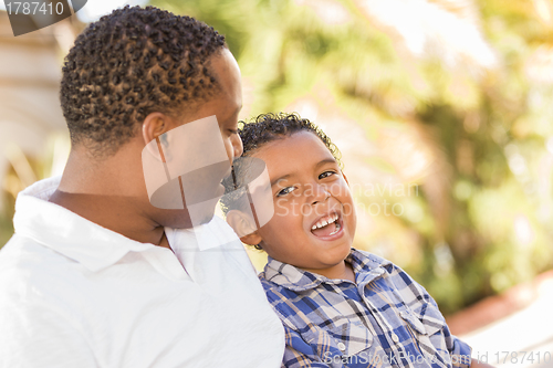 Image of Happy Mixed Race Father and Son Talking