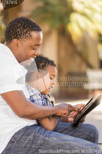 Image of Mixed Race Father and Son Using Touch Pad Computer Tablet