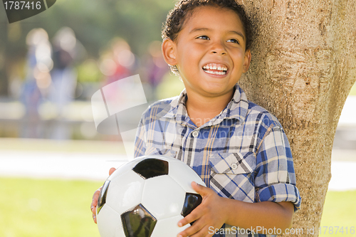 Image of Mixed Race Boy Holding Soccer Ball in the Park