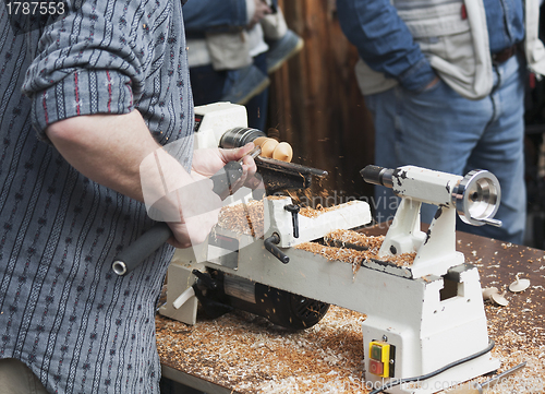 Image of Man making wooden toy