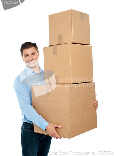 Image of Happy young man carrying heavy packages