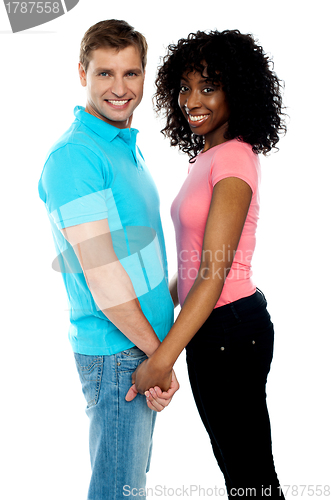 Image of Happy young couple holding hands