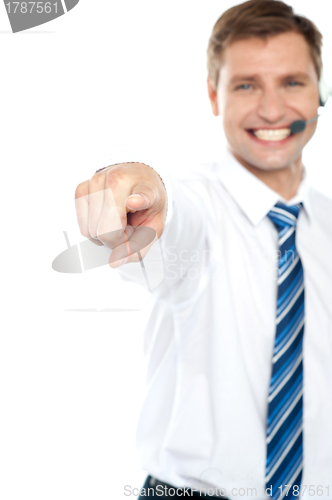 Image of Cheerful male executive pointing at you