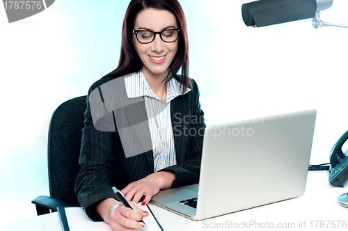 Image of Businesswoman writing an important document