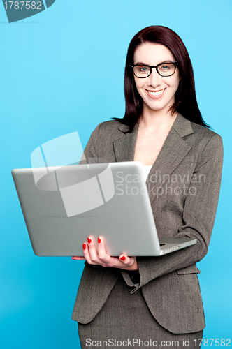 Image of Young corporate woman working on laptop