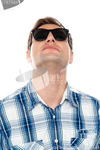 Image of Casual young man looking upwards
