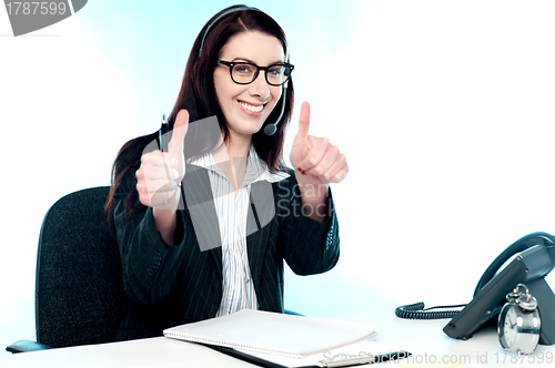 Image of Call centre operator gesturing double thumbs up