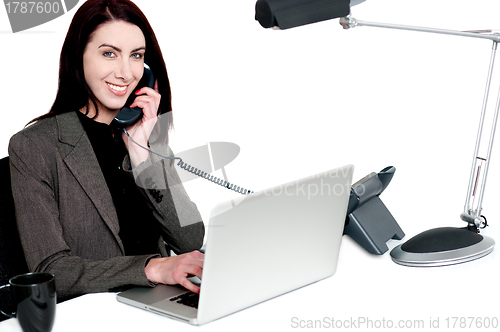 Image of Female operator talking on phone and smiling
