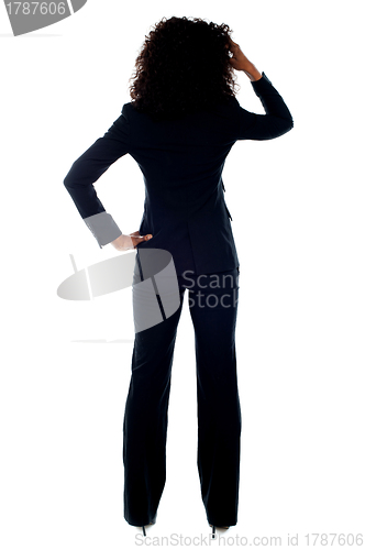 Image of Rear view portrait of confused businesswoman