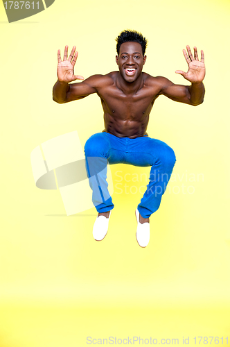 Image of Shirtless young guy jumping high in the air