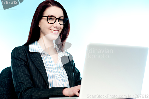 Image of Young business executive working on laptop