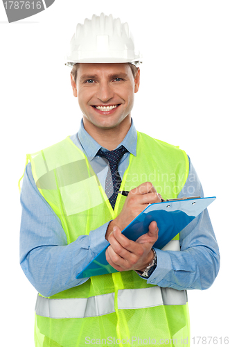 Image of Construction engineer writing on notepad