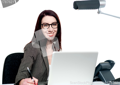 Image of Happy young woman working in office