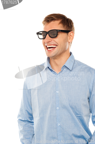 Image of Joyful young man wearing goggles looking away