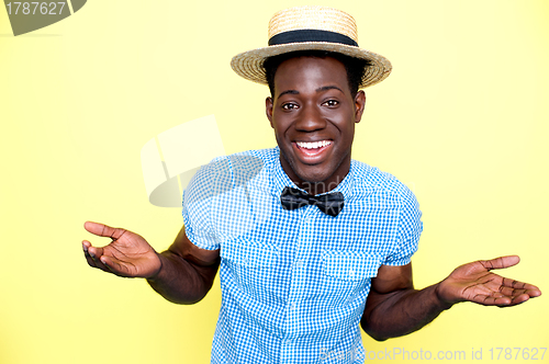 Image of Young african guy with hat enjoying himself