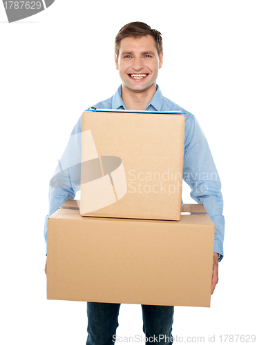 Image of Young man holding cardboard boxes