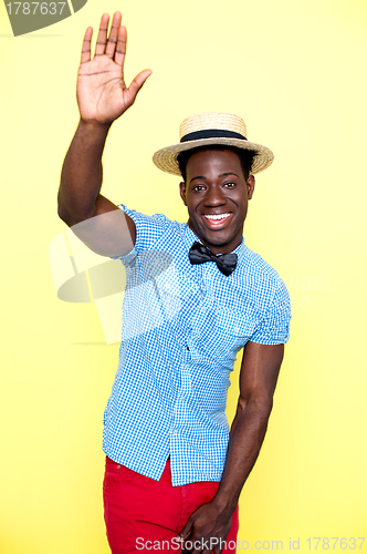 Image of Casual young african guy posing with raised arm