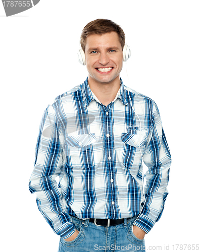 Image of Casual caucasian guy listening to music