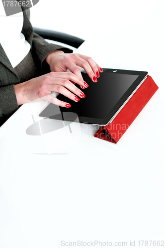 Image of Cropped image of a businesswoman using tablet pc