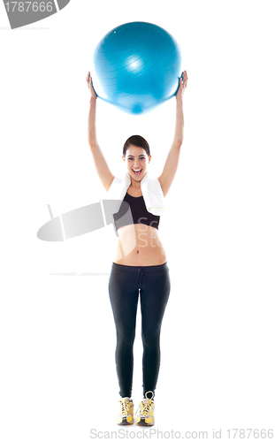 Image of Gorgeous fit lady holding pilate ball