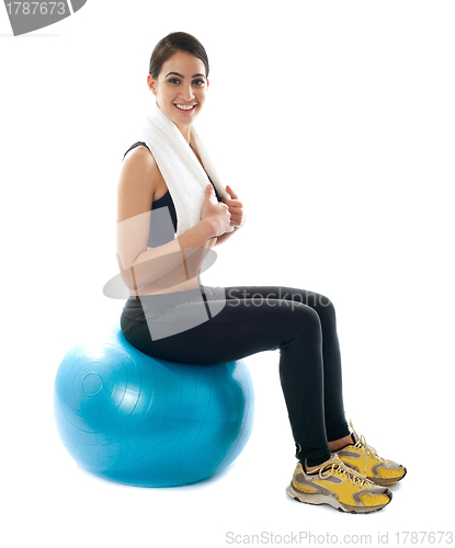 Image of Female fitness trainer sitting on ball