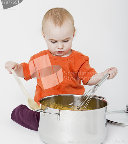 Image of baby with big cooking pot