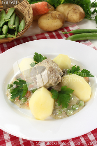 Image of cooked meatballs in a white sauce with capers