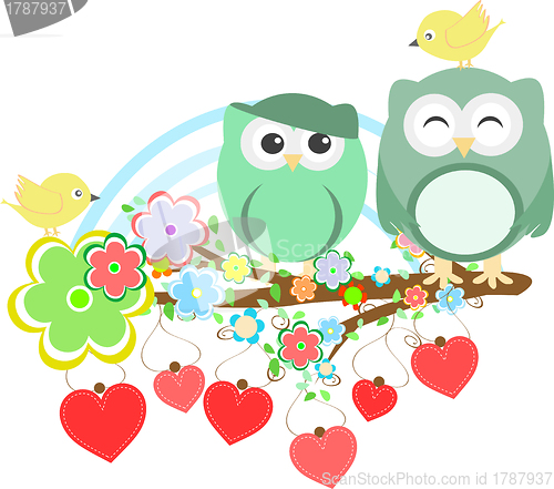 Image of Two cute owls and bird on the flower tree branch