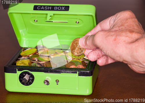 Image of Green cash box with gold and silver coins
