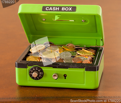 Image of Green cash box with gold and silver coins