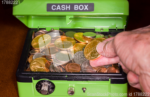 Image of Green cash box with gold and silver coins