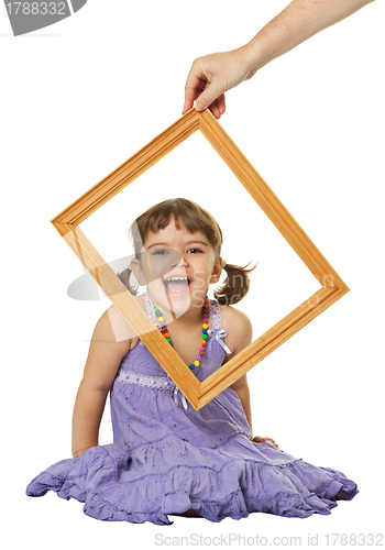 Image of Happy little girl looking through the frame