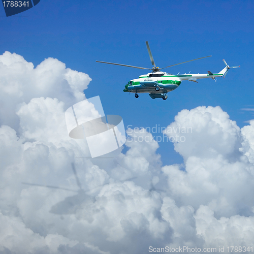 Image of Helicopter flying above the clouds
