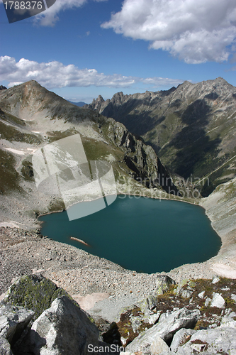 Image of Lake in mountains. Alpine latitudes at different times of the ye