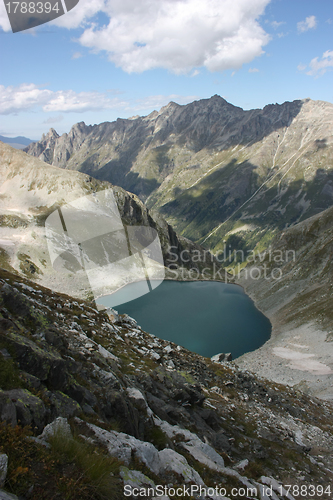 Image of Lake in mountains. Alpine latitudes at different times of the ye