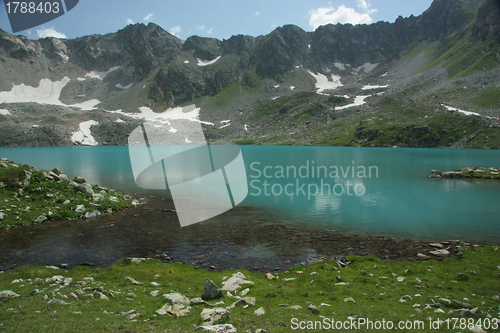 Image of Lake in mountains. Alpine latitudes at different times of the ye