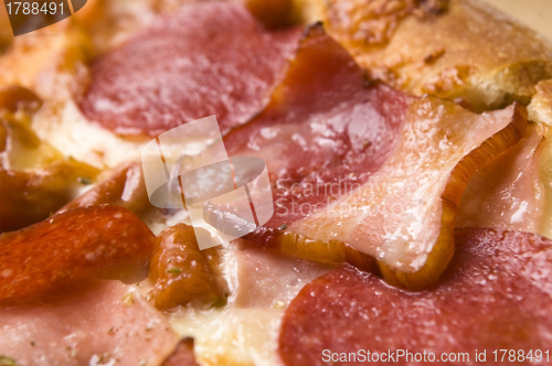 Image of Italian pizza with bacon, salami and mozzarella cheese