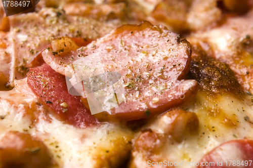 Image of Italian pizza with bacon, salami and mozzarella cheese