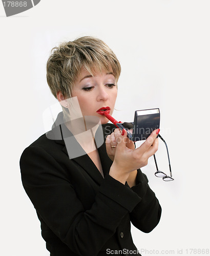 Image of Businesswoman fixing her makeup