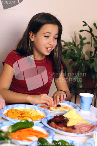 Image of Girl having fun with her food